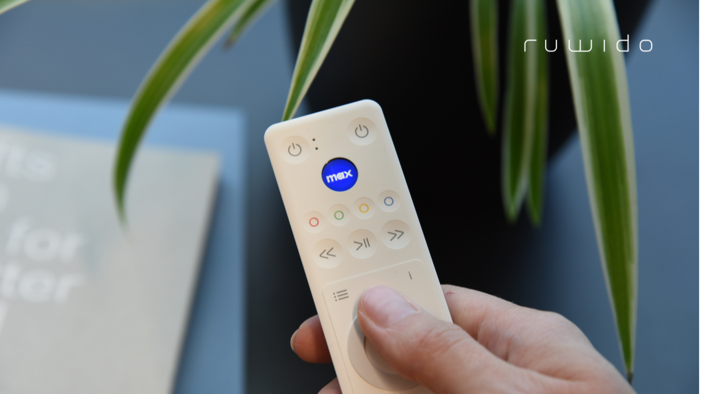 The remote control features a programmable touch-sensitive LCD button